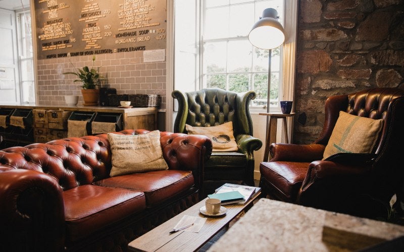 A cozy leather couch and chair showcasing tips for long-term leather furniture storage
