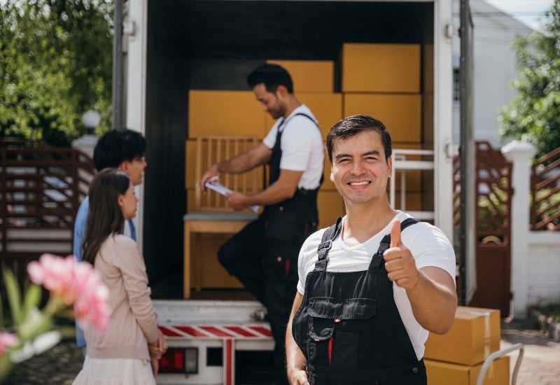 A smiling mover with a truck, showing the benefits of self-storage during a move in Mountain View, CA