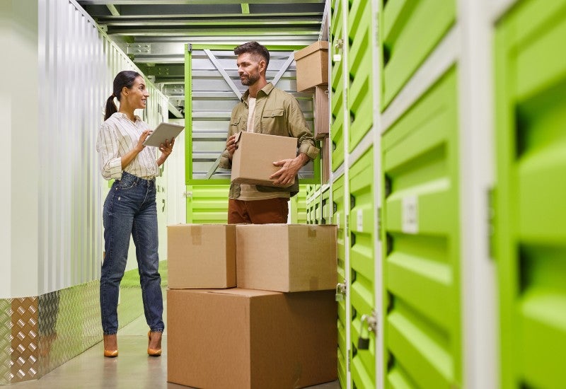 A man with a box and a woman with a tablet reviewing the Self-Storage Checklist in Mountain View, CA